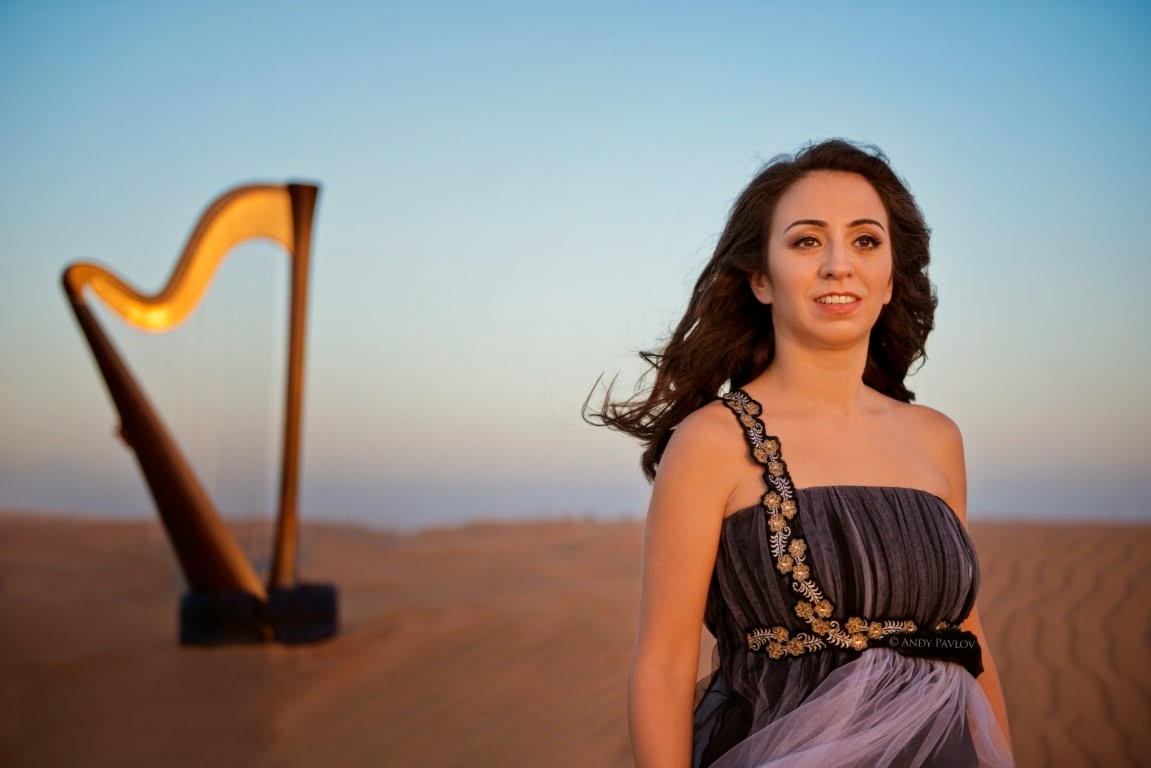 Lidia playing harp in an elegant interior